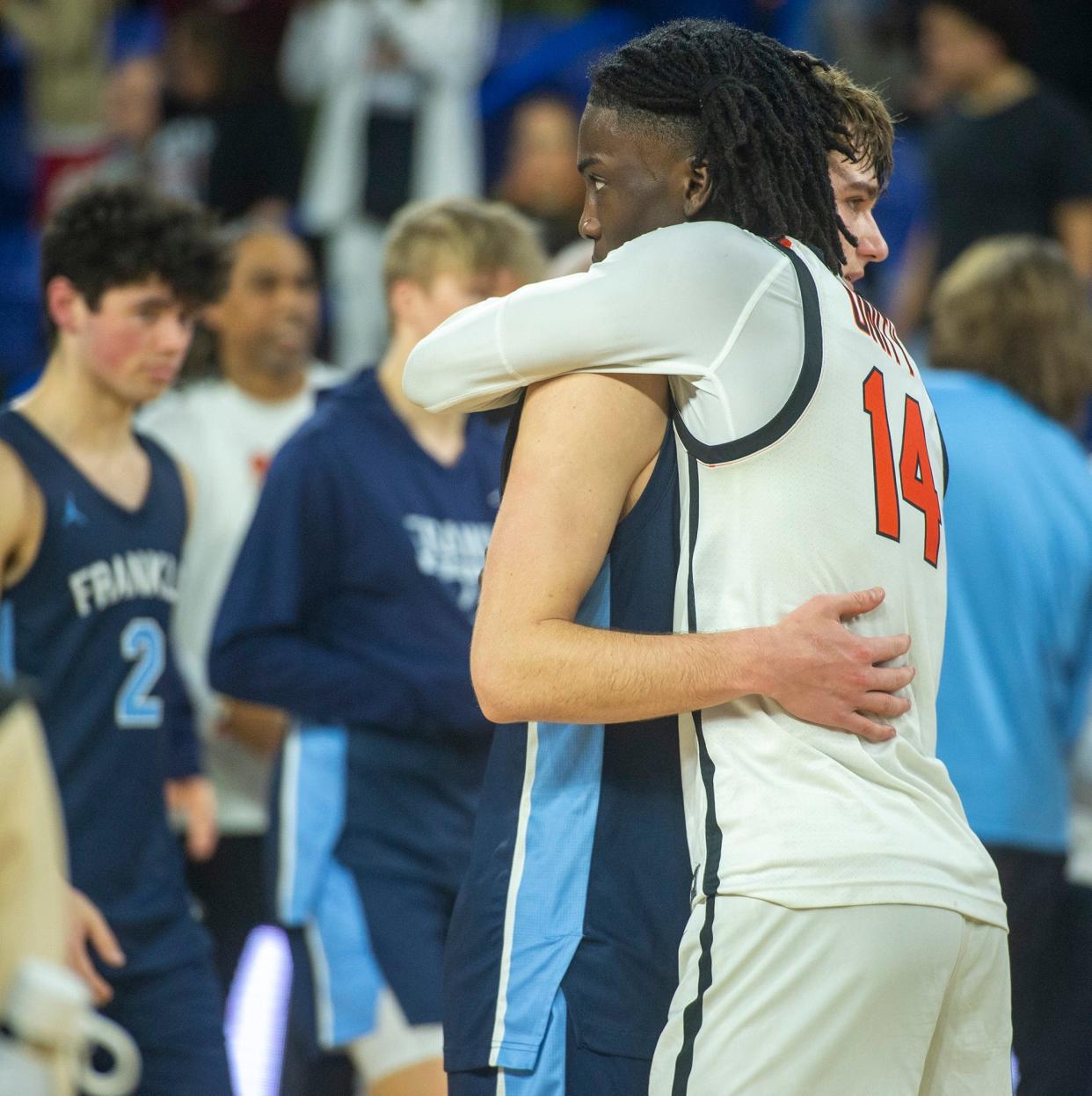 Worcester North senior Teshuan Steele, right, embraces Franklin High School senior captain Sean O'Leary after Franklin was defeated 59-53 in the Div. 1 state boys basketball final at the Tsongas Center in Lowell, March 17, 2024.