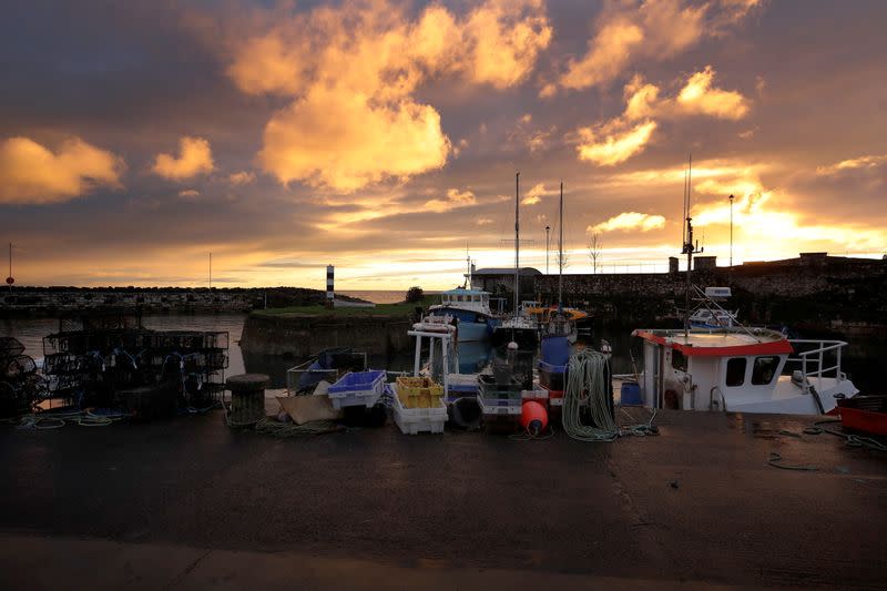 Sun rises over the Irish Sea fishing village of Carnlough