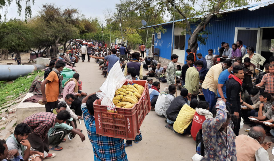 Homeless and impoverished Indians receive food at a government shelter in New Delhi, India, Thursday, March 26, 2020. Some of India's legions of poor and people suddenly thrown out of work by a nationwide stay-at-home order began receiving aid distribution Thursday, as both the public and private sector work to blunt the impact of efforts to curb the coronavirus pandemic. (AP Photo)