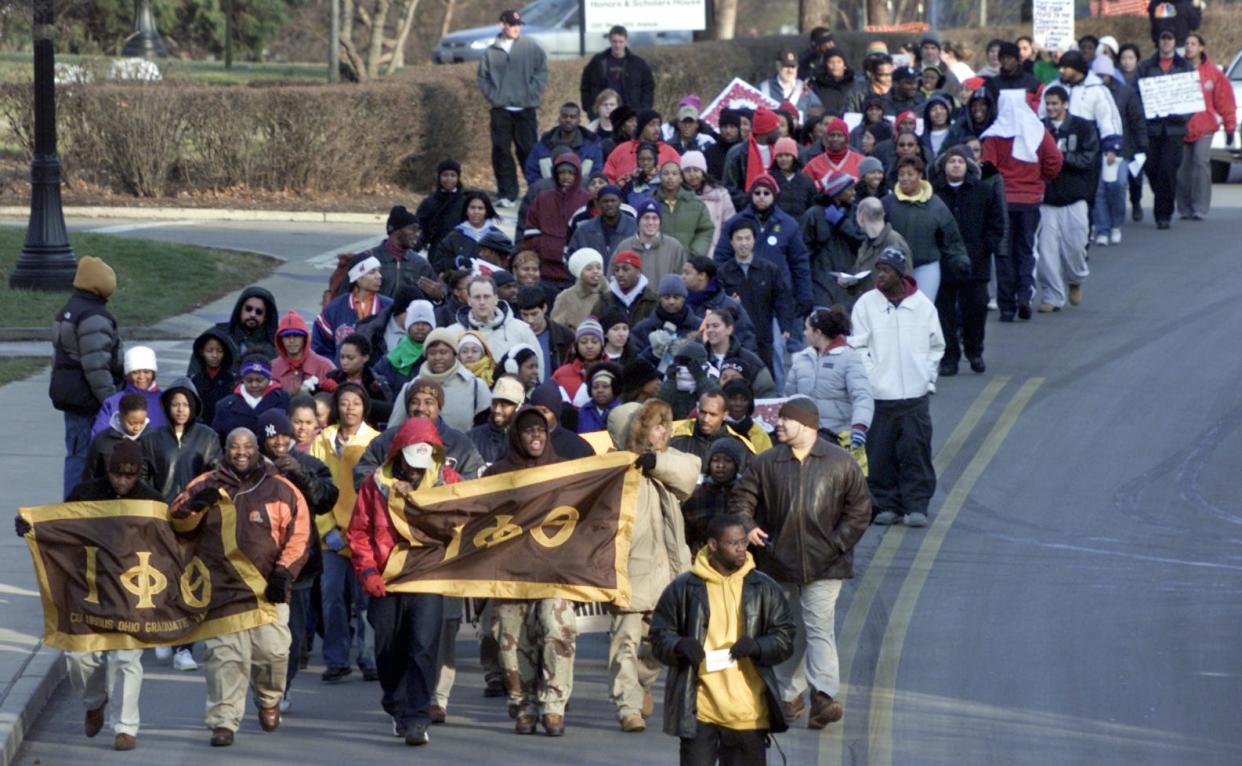 The first Ohio State March for Martin Luther King Jr. Day in 2002 proceeds west on 12th Avenue on campus en route to Downtown.