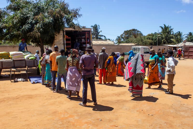 People queue at a World Food Progamme (WFP) cash-based food assistance site for displaced people in Cabo Delgado province, in Pemba, Mozambique