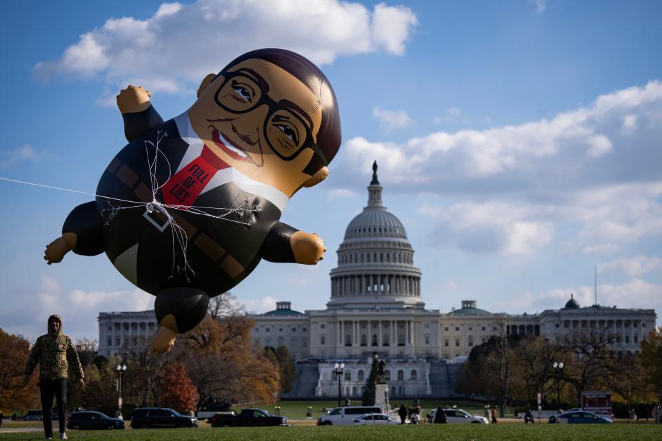 Progressive activists with MoveOn display a 15-foot inflatable of Rep. George Santos, R-N.Y., as they call for his expulsion from Congress on Capitol Hill November 28, 2023 in Washington, D.C.