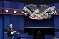 A worker sprays sanitizer on a lectern as preparations take place for the first Presidential debate in the Sheila and Eric Samson Pavilion, Monday, Sept. 28, 2020, in Cleveland. The first debate between President Donald Trump and Democratic presidential candidate, former Vice President Joe Biden is scheduled to take place Tuesday, Sept. 29. (AP Photo/Patrick Semansky)