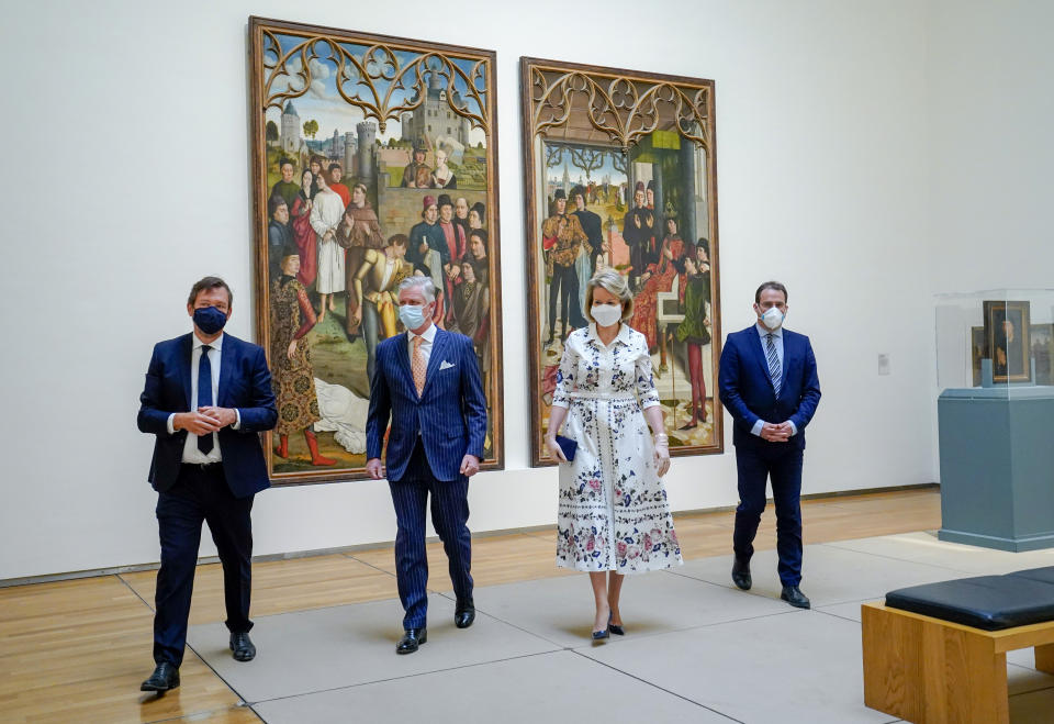 Belgium's King Philippe, center left, and Belgium's Queen Mathilde, center right, wear face masks, to prevent the spread of coronavirus, as they visit the Royal Museum of Fine Arts in Brussels, Tuesday, May 19, 2020. Museums are hesitantly starting to reopen as the coronavirus lockdown measures are relaxed, yet experts say that one in eight in the world could potentially face permanent closure because of the pandemic. (Daina Le Lardic, Pool Photo via AP)
