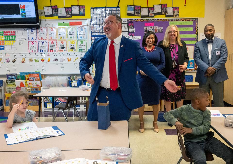 U.S. Secretary of Education Miguel Cardona smiles after being rejected while offering chocolate to kids in a pre-K classroom at Avondale Elementary School.
