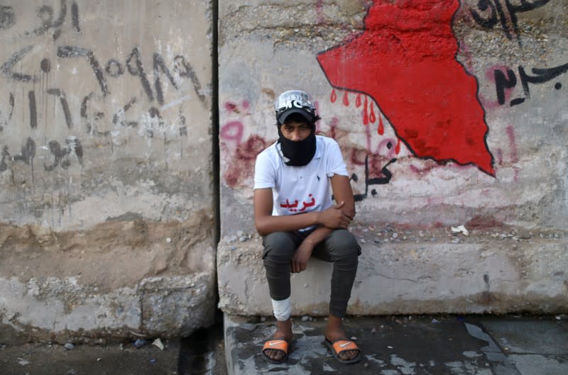 Mortada, an Iraqi demonstrator, poses for a photograph during the ongoing anti-government protests in Baghdad