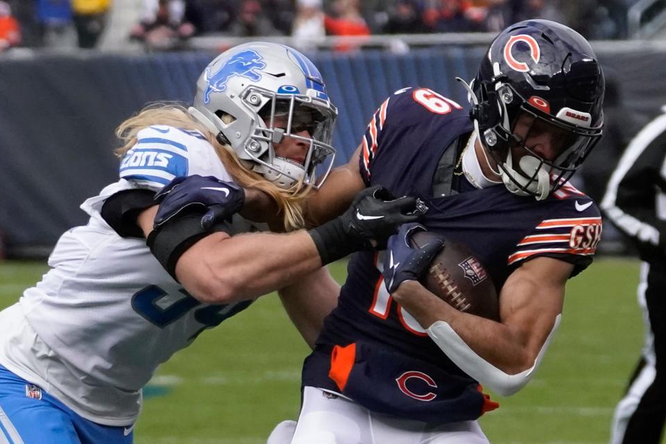 Chicago Bears wide receiver Equanimeous St. Brown (right) tries to break the tackle of Detroit Lions linebacker Alex Anzalone during the first half in Chicago, Sunday, Nov. 13, 2022.