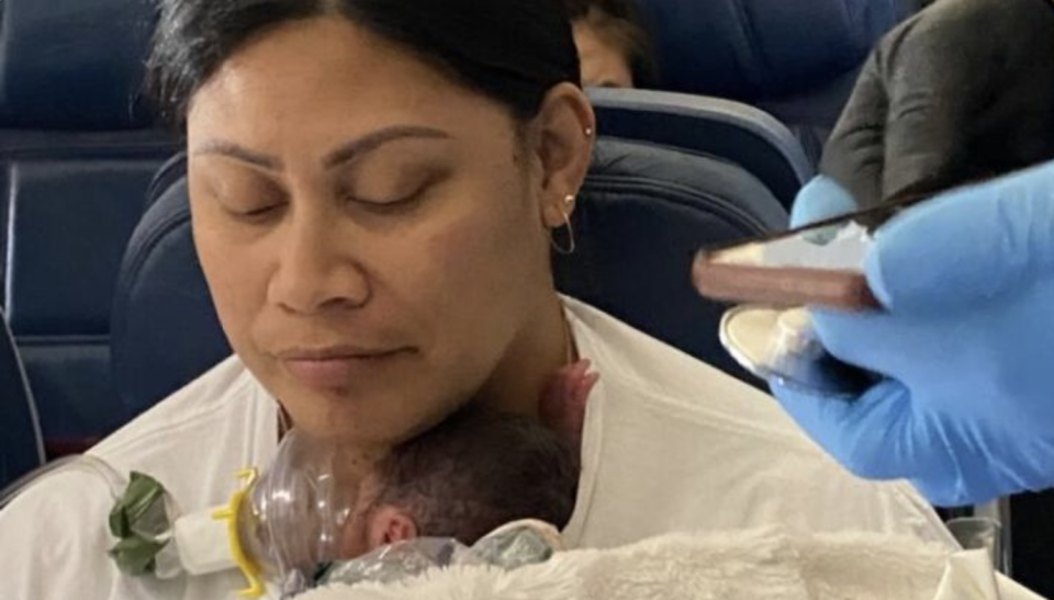 Lavinia Mounga with her newborn on her chest after giving birth on a flight to Hawaii.