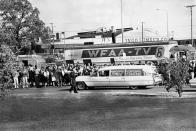 People are lining the street as the hearse bearing the body of slain U.S. President John F. Kennedy leaves Parkland Hospital in Dallas, Texas, to be flown to Washington on Nov. 22, 1963. (Photo:AP)