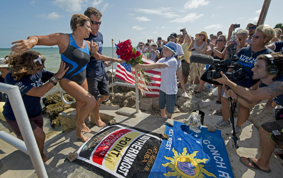 KEY WEST, FL - AUGUST 21: In this photo provided by the Florida Keys News Bureau, endurance swimmer Diana Nyad is helped to shore and welcomed by her team after swimming a short distance from a support boat August 21, 2012 in Key West, Florida. Nyad failed in a fourth attempt to complete a swim across the Florida Straits from Cuba to the Florida Keys. (Photo by Andy Newman/Florida Keys News Bureau via Getty Images)