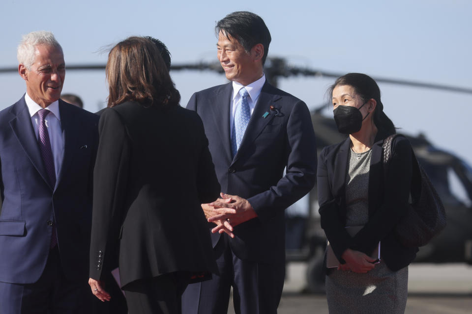 U.S. Vice President Kamala Harris, second left, is greeted by U.S. Ambassador to Japan Rahm Emanuel and Japanese Vice Foreign Minister Kenji Yamada at Yokota Air Base on the outskirts of Tokyo Monday, Sept. 26, 2022. (Leah Millis/Pool Photo via AP)