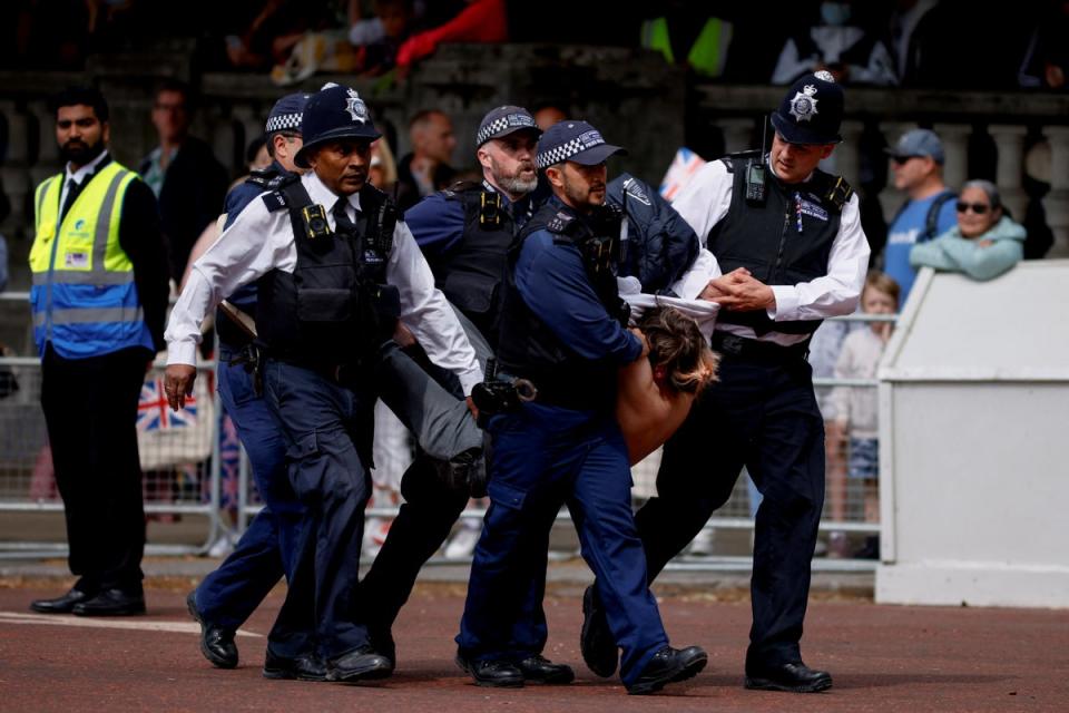 Police officers detain a protester who tried to disrupt the ceremony during the Queen's Platinum Jubilee celebrations (REUTERS)