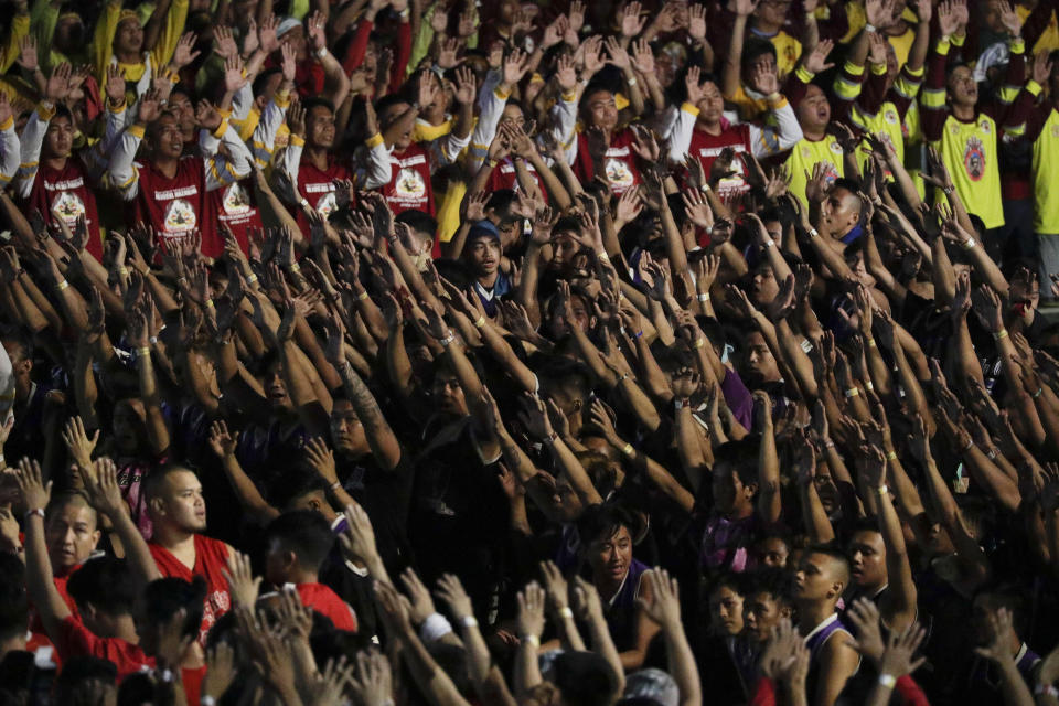 A crowd of Filipino Roman Catholic devotees raise their hands during prayers to celebrate the feast day of the Black Nazarene on Thursday, Jan. 9, 2020 in Manila, Philippines. A mammoth crowd of mostly barefoot Filipino Catholics prayed for peace in the increasingly volatile Middle East at the start Thursday of an annual procession of a centuries-old black statue of Jesus Christ in one of AsiaÅfs biggest religious events. (AP Photo/Aaron Favila)