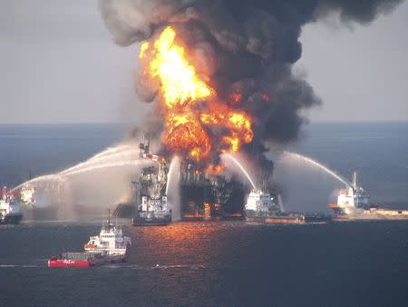 Fire boat response crews battle the blazing remnants of the off shore oil rig Deepwater Horizon, off Louisiana, in this file handout photograph taken on April 21, 2010. REUTERS/U.S. Coast Guard/Handout