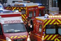 Firefighters and rescue workers gather at the site of a shooting in Montrouge, south of Paris