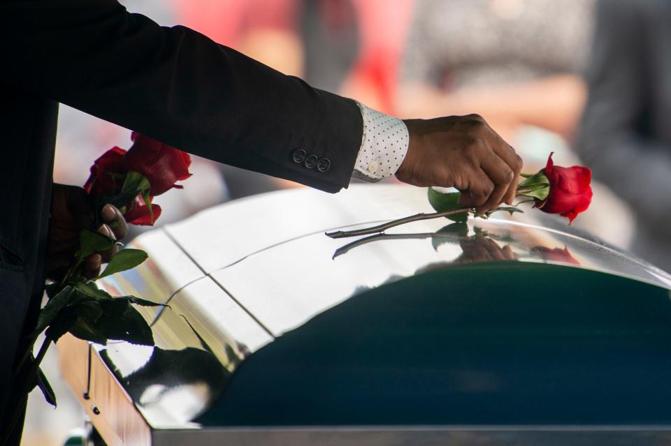 Roses are gently placed on the top of the casket bearing Terry Deshawn Childress at Meadowlawn Garden of Peace on Saturday, March 13, 2021 in Toney, Ala. Childress was an inmate at the Trousdale Turner prison when he was killed in February. Officials have classified his death as a homicide, the third suspected murder at the facility in about a year. 