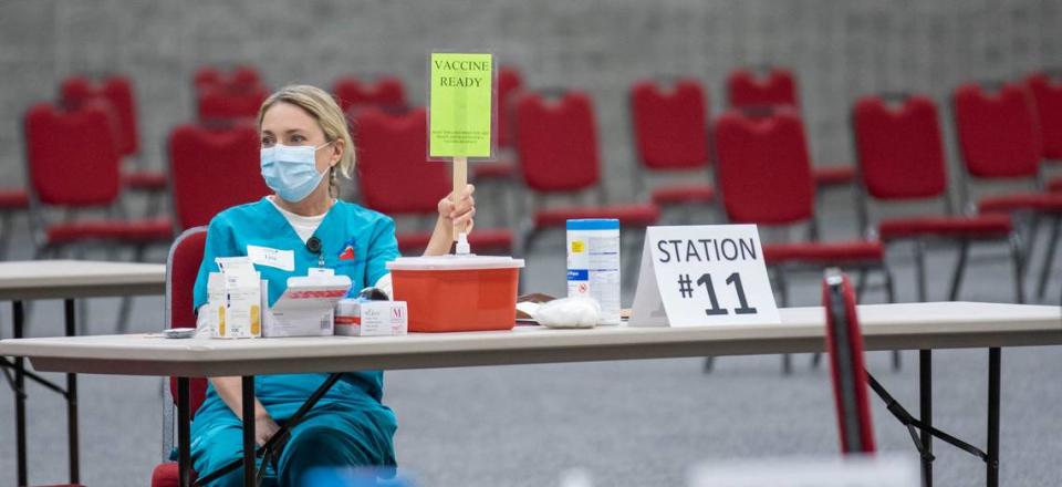 Lisa Foxworth raises a sign indicating she is ready to administer a coronavirus vaccination during a vaccination clinic for hospitality workers. The South Carolina Restaurant and Lodging Association partnered with Loveless Family Medicine to provide about 400 vaccines at the Columbia Convention Center.