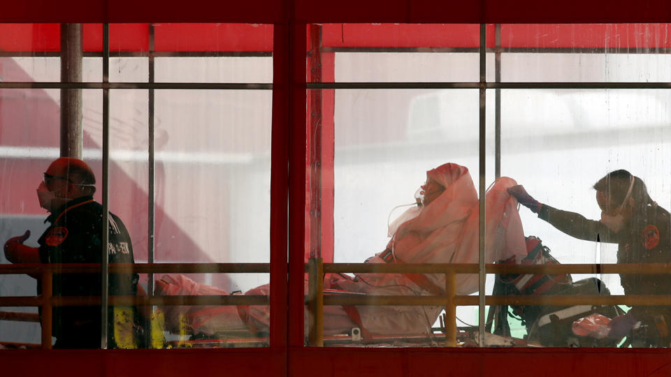 Emergency medical technicians wheel a patient into Elmhurst Hospital Center's emergency room on April 7, 2020, in the Queens borough in New York, during the current coronavirus outbreak. (Kathy Willens/AP)