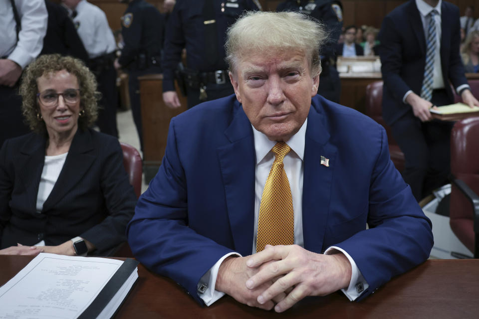 Former President Donald Trump, center, and attorney Susan Necheles, left, attend his trial at Manhattan criminal court on Tuesday, May 7, 2024, in New York. (Win McNamee/Pool Photo via AP)