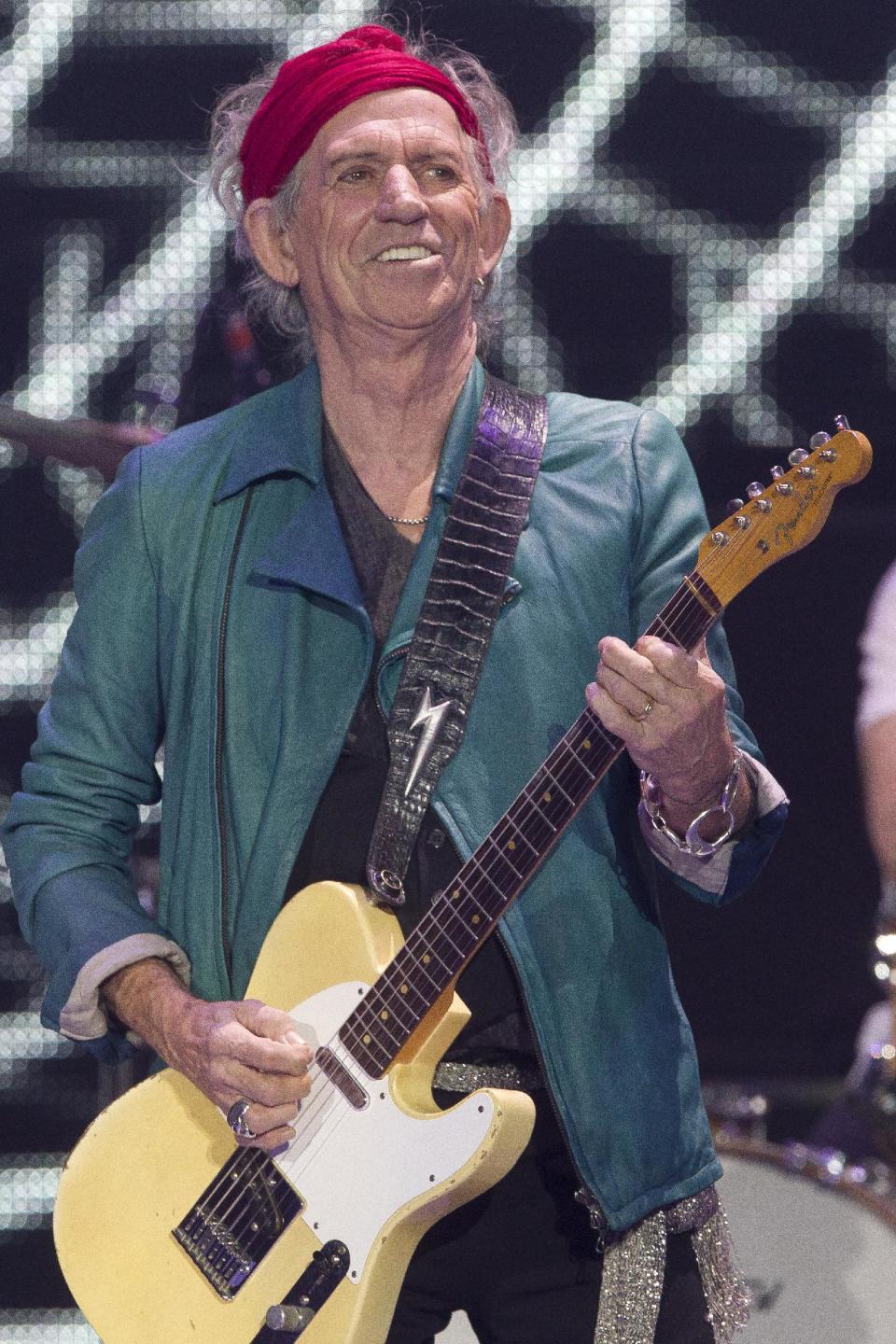 Keith Richards of The Rolling Stones performs at the O2 arena in east London, Sunday, Nov. 25, 2012. The band are playing four gigs to celebrate their 50th anniversary, including two shows at London’s O2 and two more in New York. (Photo by Joel Ryan/Invision/AP)