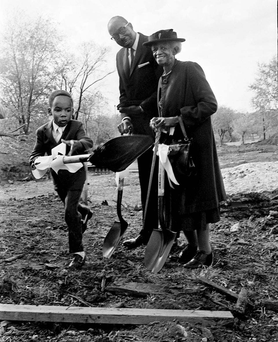 Jeffrey Crawford, left, the youngest member of Kayne Avenue Baptist, energetically tosses the first shovelful of dirt during the groundbreaking services for a new sanctuary at 12th Avenue South Nov. 14, 1971. Looking on is Rev. Albert G. Jones, pastor, and Mrs. Hattie Lawrence, one of the oldest members of the church.