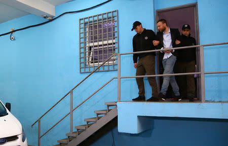 Jack Shepherd, who went on the run last year after killing a woman in a speedboat crash on the River Thames, is escorted during his extradition in Tbilisi, Georgia April 10, 2019. The Ministry of Internal Affairs of Georgia/Handout via REUTERS