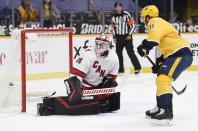 Nashville Predators center Luke Kunin (11) scores a goal against Carolina Hurricanes goaltender Alex Nedeljkovic (39) during the second period of an NHL hockey game Saturday, May 8, 2021, in Nashville, Tenn. (AP Photo/Mark Zaleski)