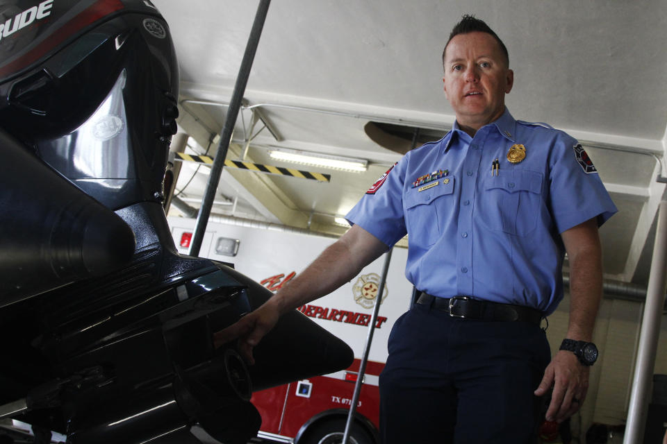 CORRECTS LAST NAME ON FIRST REFERENCE TO MENENDEZ FROM MENDOZA - In this June 13, 2019, photo, firefighter Capt. Kris Menendez shows the plastic propeller on the engine of a rescue boat used in the Rio Grand and adjacent water canals in El Paso, Texas. "They don’t realize that once they get in there, they’re feet can get swept away. There’s a lot of obstacles, there’s debris in the canal, and there are head gates,” Menendez said. The team was training near a head gate on June 11 when one of the firefighters spotted a body in the water. (AP Photo/Cedar Attanasio)