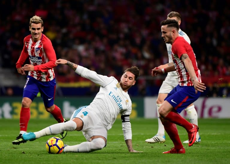 Real Madrid's Sergio Ramos (centre) in action during the Spanish league match against Atletico Madrid at the Wanda Metropolitan stadium