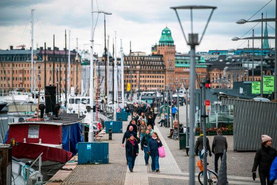 People walk at Strandvagen in Stockholm (AFP via Getty Images)