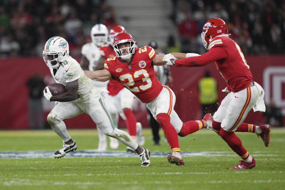 Miami Dolphins wide receiver Tyreek Hill (10) runs with the ball as Kansas City Chiefs linebacker Drue Tranquill (23) defends during the first half of an NFL football game Sunday, Nov. 5, 2023, in Frankfurt, Germany. (AP Photo/Michael Probst)
