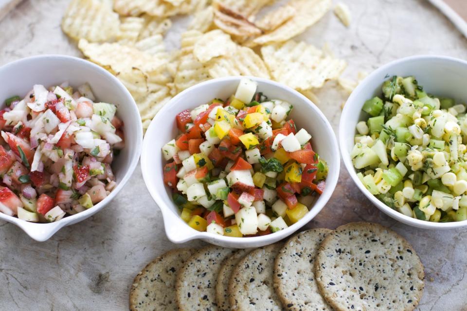 In this image taken on June 3, 2013, from left, strawberry-fennel salsa, apple-pepper salsa, and cucumber-corn salsa are shown served in bowls in Concord, N.H. (AP Photo/Matthew Mead)