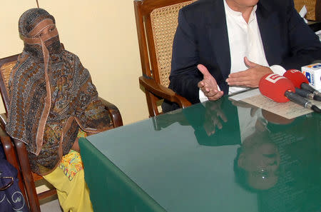 FILE PHOTO: Governor of the Punjab Province Salman Taseer is reflected as he speaks to the media after meeting with Asia Bibi, a Pakistani Christian woman who has been sentenced to death for blasphemy, at a jail in Sheikhupura, located in Pakistan's Punjab Province November 20, 2010. REUTERS/Asad Karim/File Photo