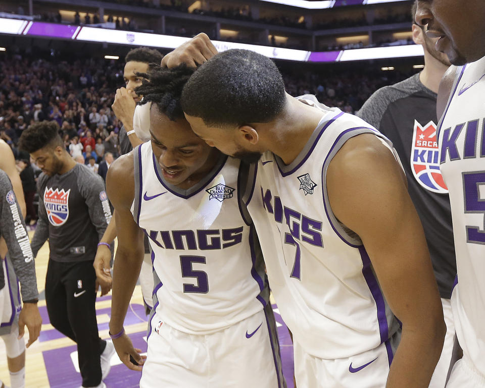 Garrett Temple (right) congratulates rookie De’Aaron Fox for hitting the game-winning jumper that pushed the Kings past the 76ers. (AP)