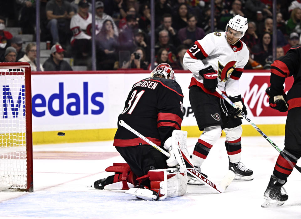 Carolina Hurricanes goaltender Frederik Andersen (31) makes a save as Ottawa Senators right wing Mathieu Joseph (21) plays in front, during the second period of an NHL hockey game in Ottawa, Ontario, on Sunday, March 17, 2024. (Justin Tang/The Canadian Press via AP)