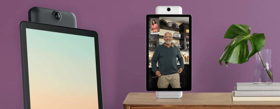 facebook portal plus on purple background on table with man smiling and purple background