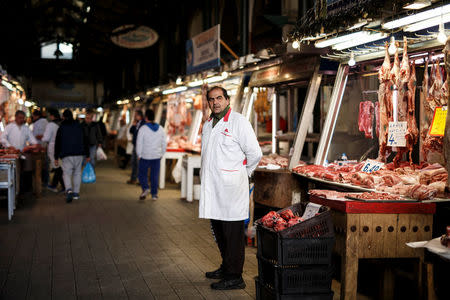 A butcher waits for clients inside the main meat market of Athens, Greece, February 17, 2017. REUTERS/Alkis Konstantinidis