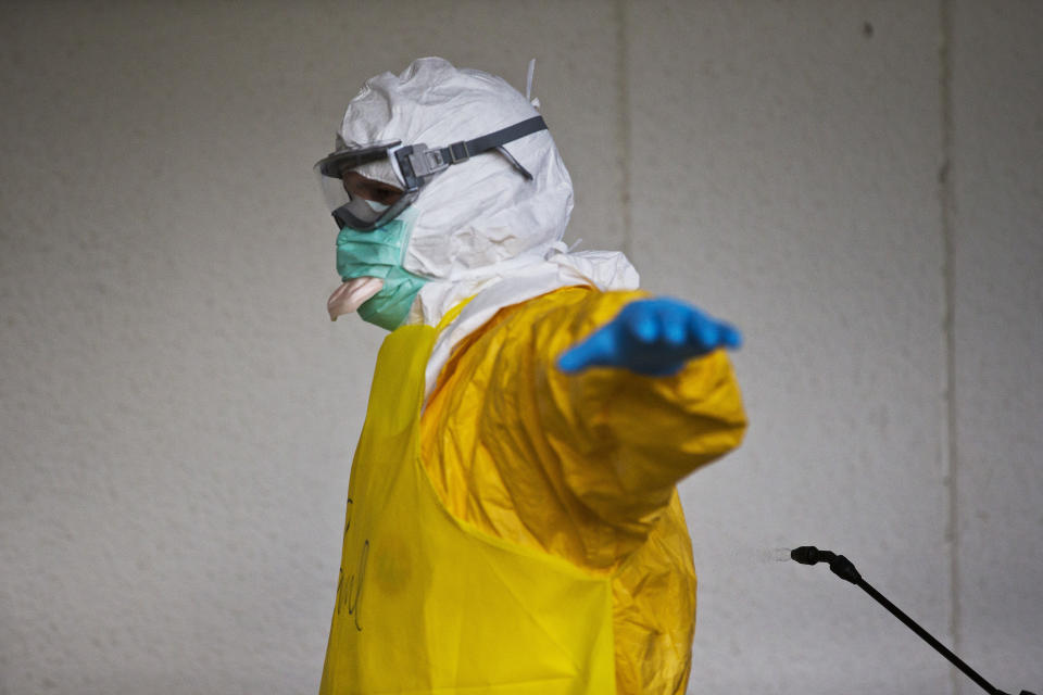 A licensed clinician is sprayed for contaminants during a simulated training session on Monday, Oct. 6, 2014, in Anniston, Ala. The Centers for Disease Control and Prevention (CDC) has developed an introductory training course for licensed clinicians. According to the CDC, the course is to ensure that clinicians intending to provide medical care to patients with Ebola have sufficient knowledge of the disease. (AP Photo/Brynn Anderson)