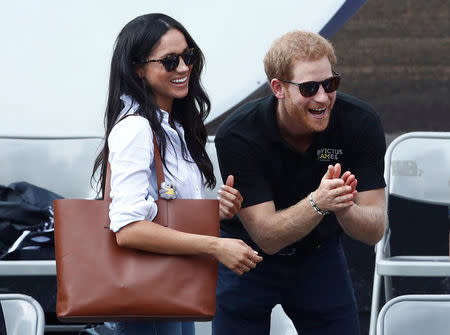 Britain's Prince Harry and his girlfriend actress Markle watch the wheelchair tennis event during the Invictus Games in Toronto, Ontario, Canada September 25, 2017. REUTERS/Mark Blinch