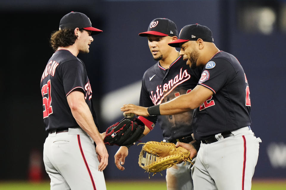 Washington Nationals relief pitcher Kyle Finnegan, left, celebrates with Ildemaro Vargas, center, and Dominic Smith after defeating the Toronto Blue Jays in a baseball game, Tuesday, Aug. 29, 2023, in Toronto. (Frank Gunn/The Canadian Press via AP)