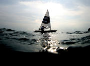 <p>Khouloud Mansy of Egypt crosses the line at the the end of the second womens laser radical class race on day two of the Games, July 25, at Enoshima Yacht Harbour.</p>