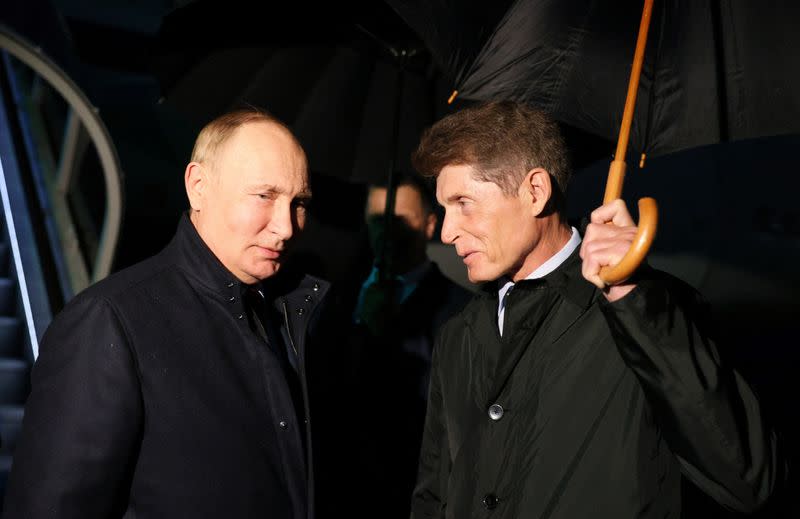 Russian President Vladimir Putin is welcomed by Governor of Primorsky Region Oleg Kozhemyako upon his arrival at Vladivostok International Airport