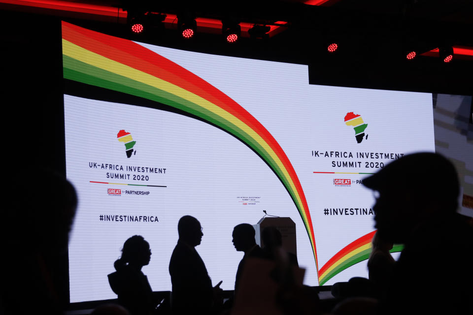 Delegates are silhouetted against the stage background before British Prime Minister Boris Johnson delivers a speech during the Opening Plenary session of the UK Africa Investment Summit in London, Monday, Jan. 20, 2020. Johnson is hosting African leaders, businesses and international institutions at the one-day summit in London. The event is taking place as Britain prepares for post-Brexit negotiations with countries around the world. (AP Photo/Matt Dunham, Pool)