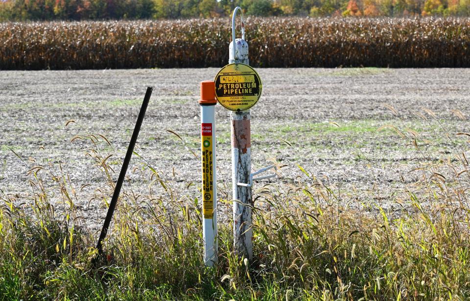 Markers are visible at the sides of farm fields along the route where the BP pipeline is buried.