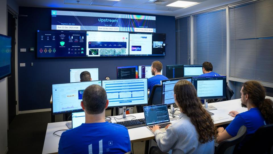 a group of people sitting at computers upstream cybersecurity patrol