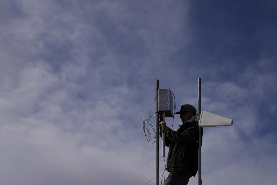Carver Cammans installs cloud seeding equipment Saturday, Dec. 3, 2022, in Lyons, Colo. The technique to get clouds to produce more snow is being used more as the Rocky Mountain region struggles with a two-decade drought. (AP Photo/Brittany Peterson)