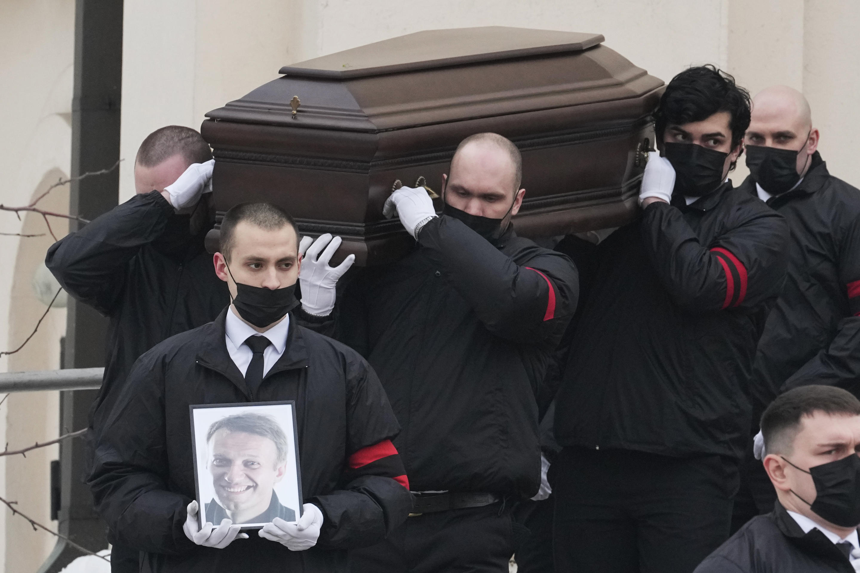 Pallbearers carry the coffin and a portrait of Russian opposition leader Alexei Navalny out of the church in Moscow where his funeral was held Friday.