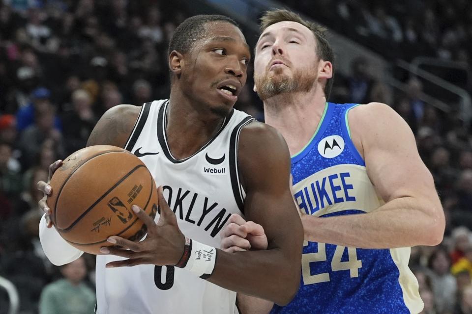 Brooklyn Nets' Lonnie Walker IV tries to get past Milwaukee Bucks' Pat Connaughton during the first half of an NBA basketball game Thursday, March 21, 2024, in Milwaukee. (AP Photo/Morry Gash)