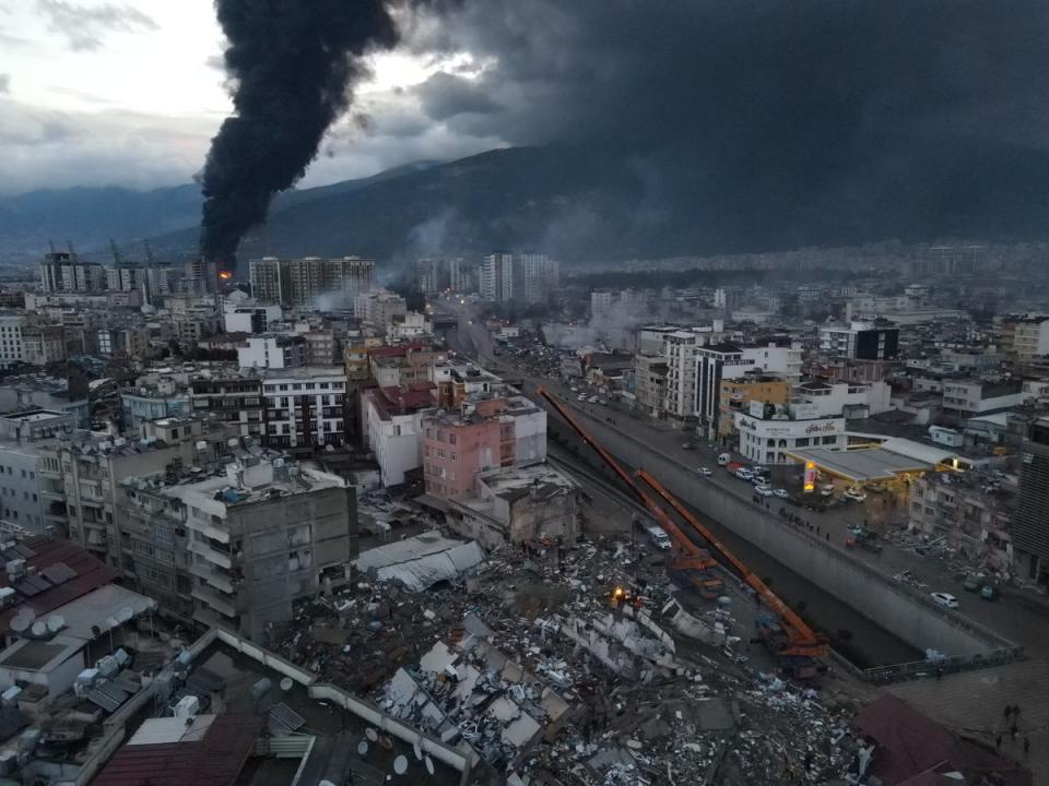 Black smoke from a fire rises over central Iskenderun, following an earthquake in Turkey (via REUTERS)