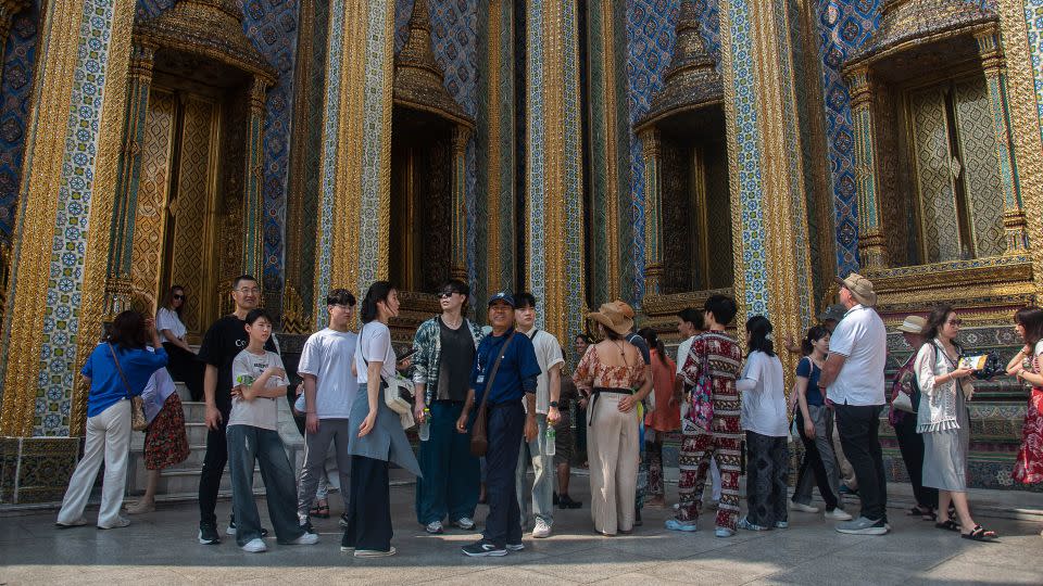 Chinese tourists visit the Temple of the Emerald Buddha in Bangkok.  - Peerapon Boonyakiat/SOPA Images/LightRocket/Getty Images